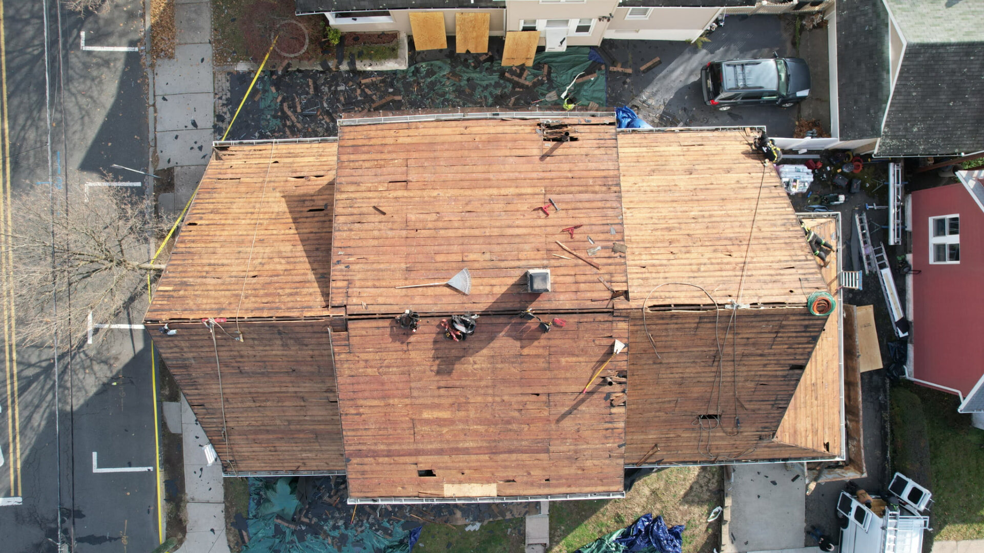 Aerial view of a New Jersey roof after old shingles were removed to expose the wood roof deck. Roofing work by Alba Pro Construction serving Clifton, NJ.