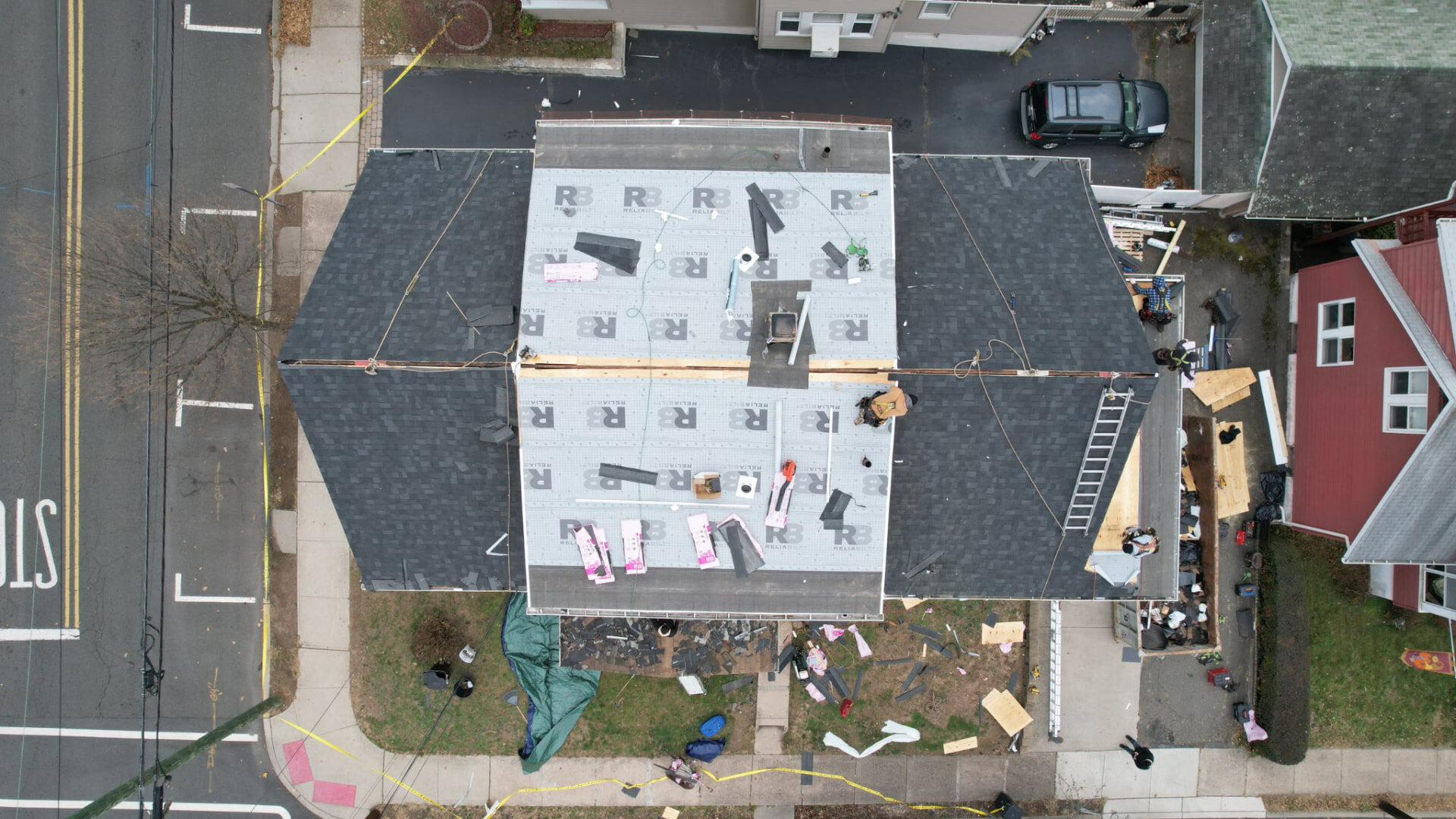 Drone view of a roof replacement with underlayment and new shingles being installed. Roofing work by Alba Pro Construction serving Wyckoff, NJ.